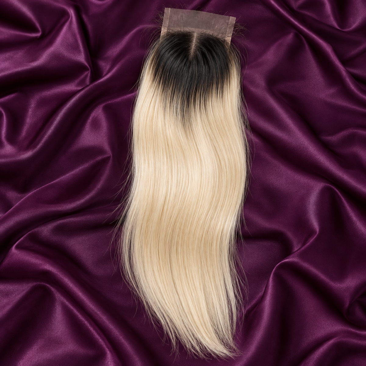 Illustrative 1B/613 ombre: short natural black root area fading to 613 pale creamy blonde lengths lace closure on plum satin